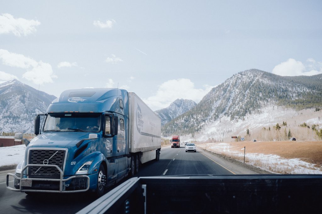 over the road trucks with mountains in background
