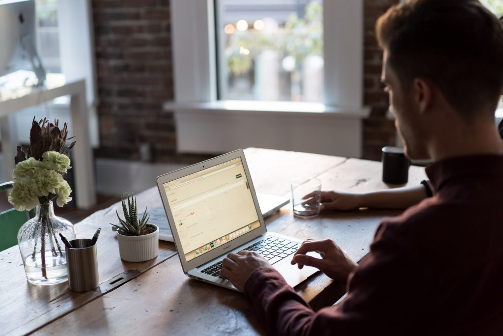 worker on laptop in dim room