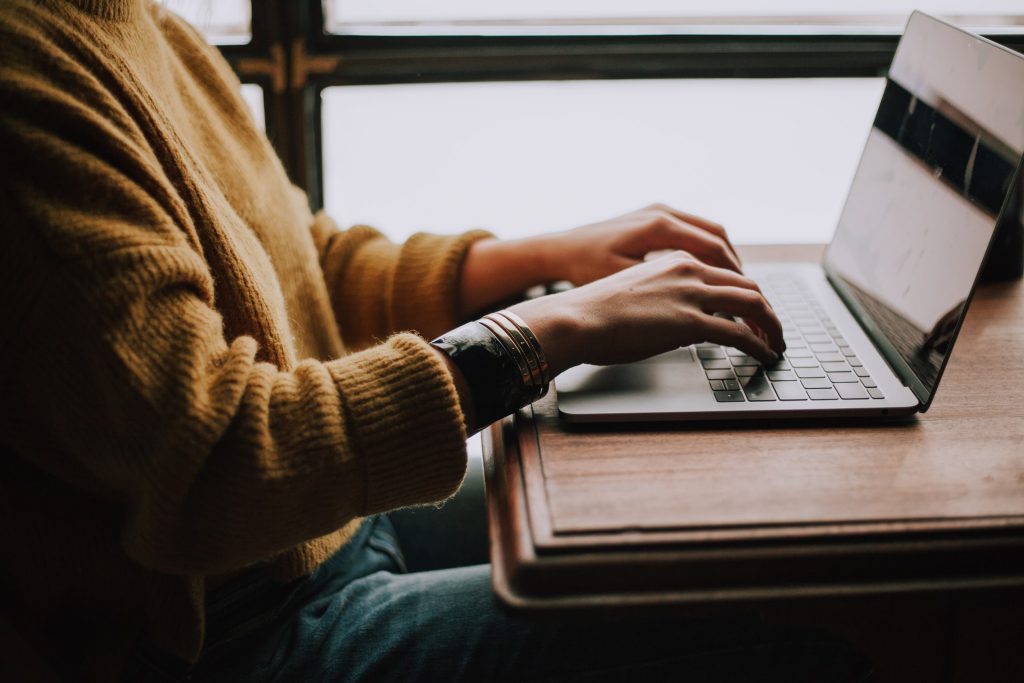 person typing on laptop at desk