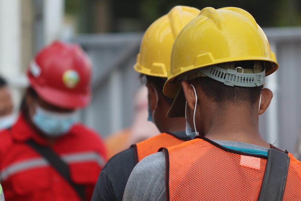workers in hard hats and safety vests