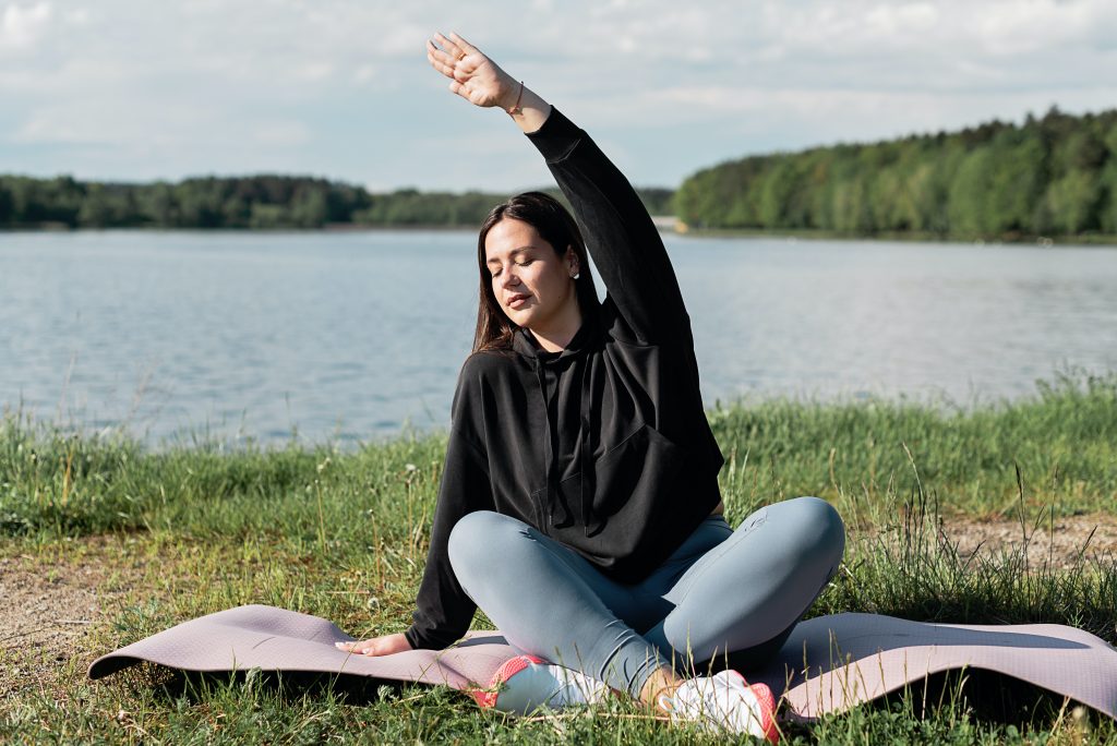 woman stretching in a park