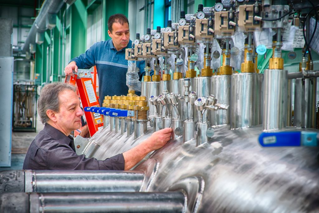 workers examining tanks and valves