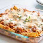 glass-baking-dish-filled-with-pasta-meat-sauce-melted-mozzarella-cheese_9975-124687