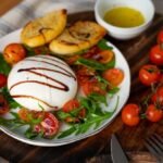 high-angle-delicious-cheese-tomatoes_23-2150062797