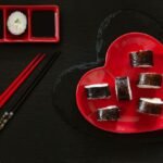 japanese-sushi-with-soy-sauce-heart-shape-red-dish-with-chopsticks_75517-919