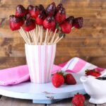 strawberry-chocolate-skewers-cup-table-close-up_392895-75430