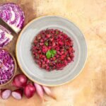 top-view-fresh-beetroot-salad-dressed-with-parsley-plate-made-red-onions-cabbage-other-veggetables-wooden-background-with-copy-space-right_140725-138656 (1)