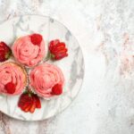 top-view-pink-strawberry-cakes-with-fresh-red-strawberries-white-surface_140725-90578