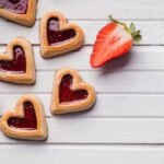 tasty-sweet-biscuits-lying-near-strawberries_23-2147802373